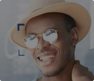 A joyful man wearing a stylish hat and round, mirrored sunglasses perfect accessory for both fashion and eye protection