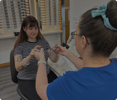 staff at Buck & Todd Optometrist in Mackay assist patients in finding frames that fit their prescription and style